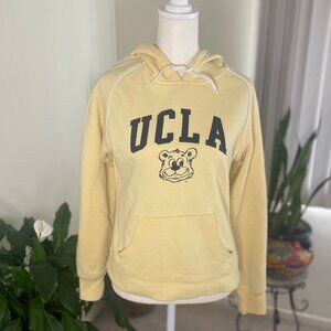 Official UCLA woman's pullover hoodie in size small. Yellow with blue print.